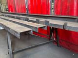 a long row of benches in a building with red curtains
