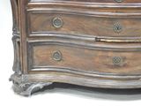 a wooden chest of drawers with a clock on top
