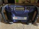 an image of a blue radio sitting on top of a carpet