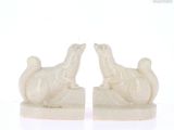 two statues of animals that are sitting on top of each other