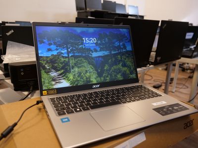 a laptop computer sitting on top of a box in a room