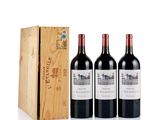 three bottles of red wine in front of a wooden box