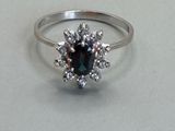 an image of a ring with a sapphire and diamonds