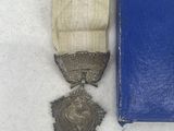 two medals and a book sitting on a table