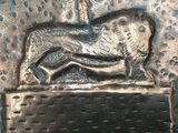 a metal sculpture of a horse on top of a box
