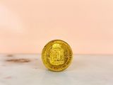 an image of a gold coin sitting on top of a marble counter