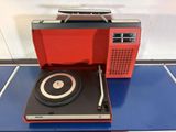 a red record player sitting on top of a blue table