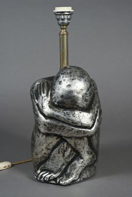 an image of a sculpture of a person holding a lamp