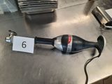 a black and silver blow dryer sitting on a table