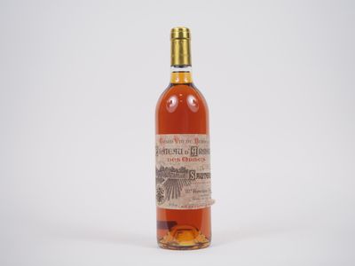 une vieille bouteille de whisky posée sur une surface blanche