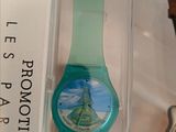 a watch in a box with a picture of the eiffel tower on it