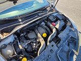 the engine of a car with its hood open on the street