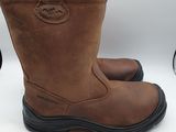 a pair of brown boots with black soles on a white surface