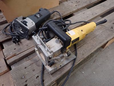 two electric tools sitting on a pallet on a pallet