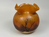 a vase with a tree on it on a white surface