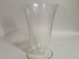a clear glass vase sitting on a white surface