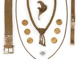 an assortment of gold jewelry including a necklace, bracelet, and ring