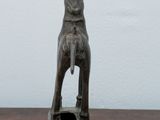 a statue of a dog sitting on a wooden table