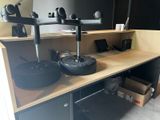 a desk with two speakers and a laptop on it