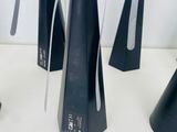 five black cone shaped vases sitting on a table