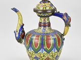 an image of a colorful vase with a bird on top of it