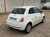 a small white car that is parked in a parking lot