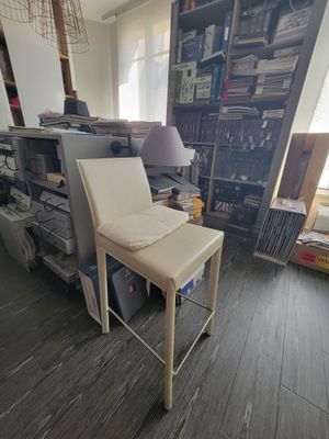 a chair that is sitting in a room with a book shelf