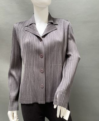 the mannequin is wearing a gray jacket and black pants