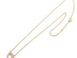 a gold necklace with a diamond crescent pendant and a chain