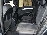 the back seats of a car in a garage with the door open