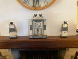 a clock that is on the mantle of a fireplace