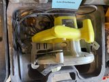 a yellow object in a plastic case with a yellow handle