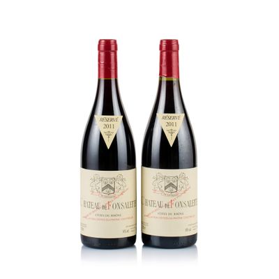 two bottles of red wine sitting next to each other on a white surface
