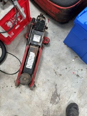 a person standing next to a pile of tools on the floor