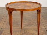 an image of a round table with a wooden top on a parquet floor