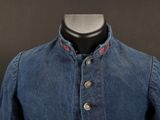 a close up of a blue jean jacket on a mannequin dummy