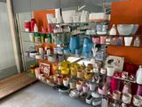 many cups and mugs on the shelves in the store