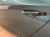 a close up of a car door handle with a sticker on it