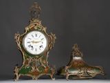 two clocks sitting next to each other on a table