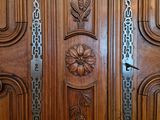 a close up of a wooden door with metal handles