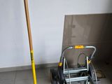 a broom and a rake on the floor in a room