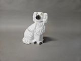 a figurine of a white dog sitting on a table