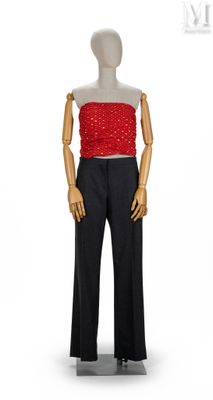 mannequin féminin vêtu d'un haut rouge et d'un pantalon noir sur fond blanc