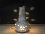 a lamp that is sitting on a table in the dark