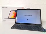 an open laptop computer sitting on top of a table next to a box