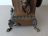 a bronze statue of a lion on top of a clock