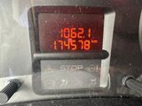 a digital clock on the dashboard of a car
