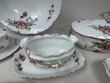 many plates and bowls that are sitting on a table