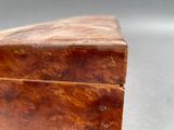 a small wooden box with a lid on a table