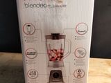 the box of the blender is sitting on the table